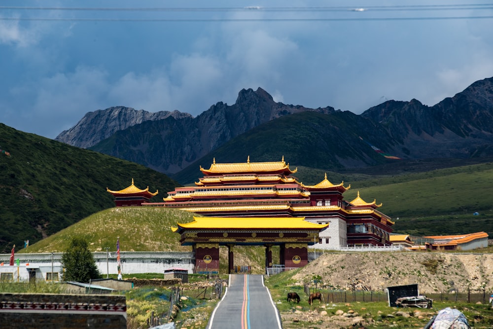 a large building with mountains in the background