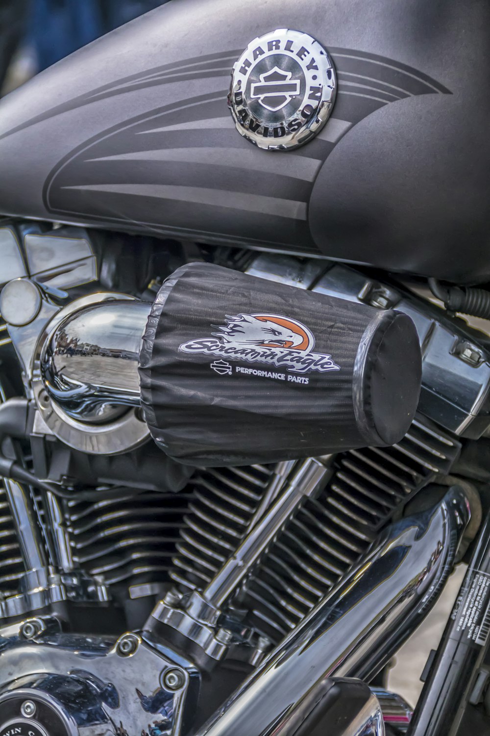 a close up of a black motorcycle with a chrome exhaust pipe