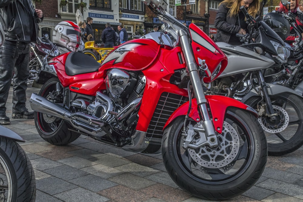 a row of motorcycles parked on the side of a street