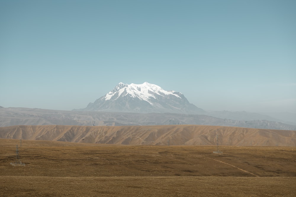a large mountain with a snow capped peak in the distance