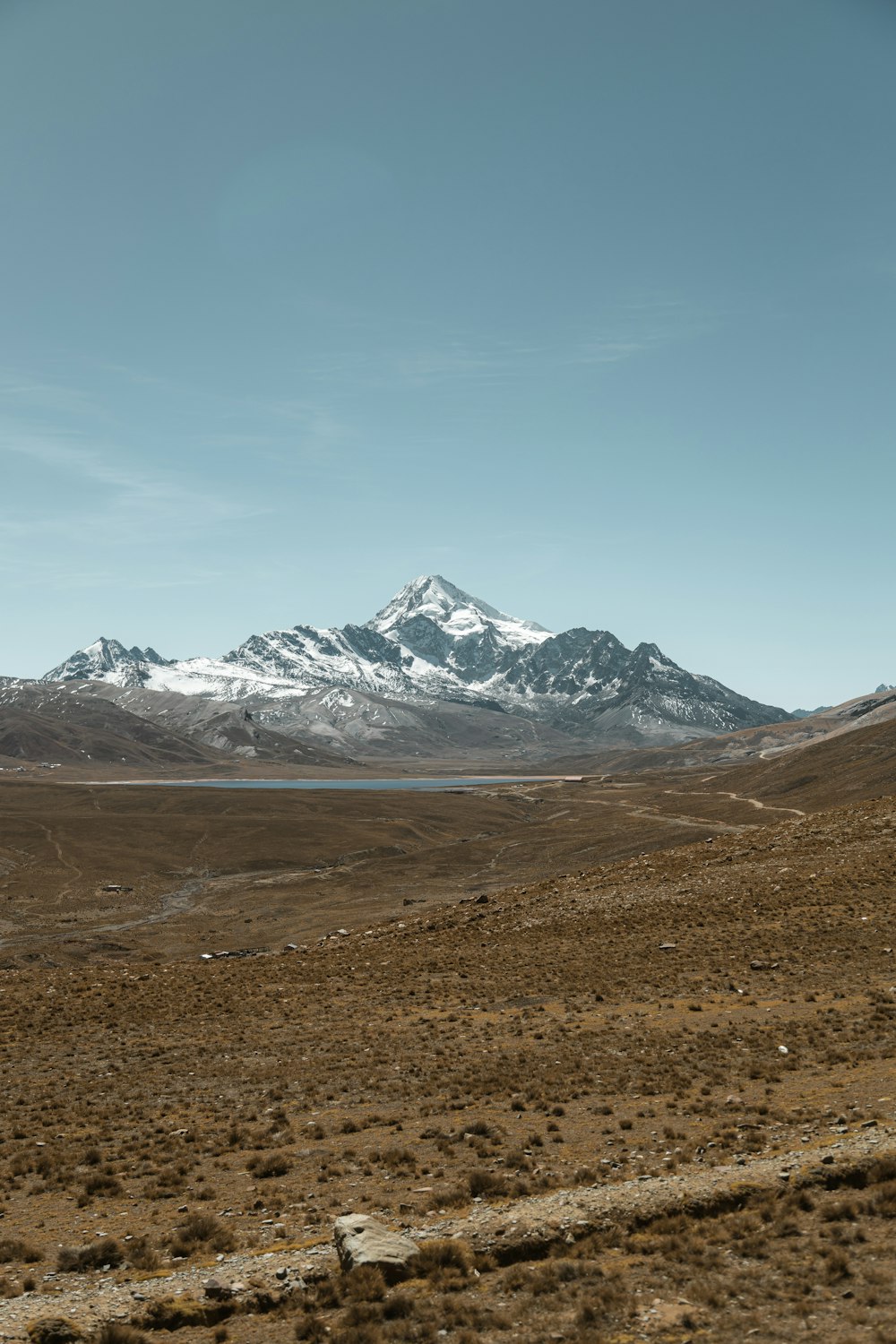 a view of a mountain range with a lake in the foreground