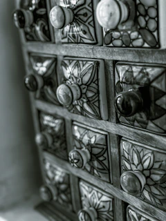 A beautifully restored vintage chest of drawers with soft pastel paint and delicate brass handles.