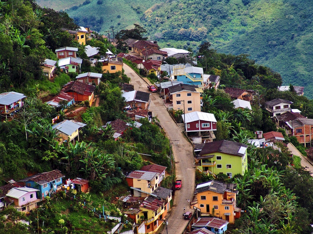 a small village on a hill with lots of trees