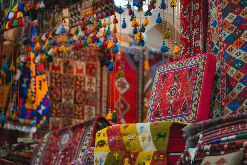 a room filled with lots of different colored rugs