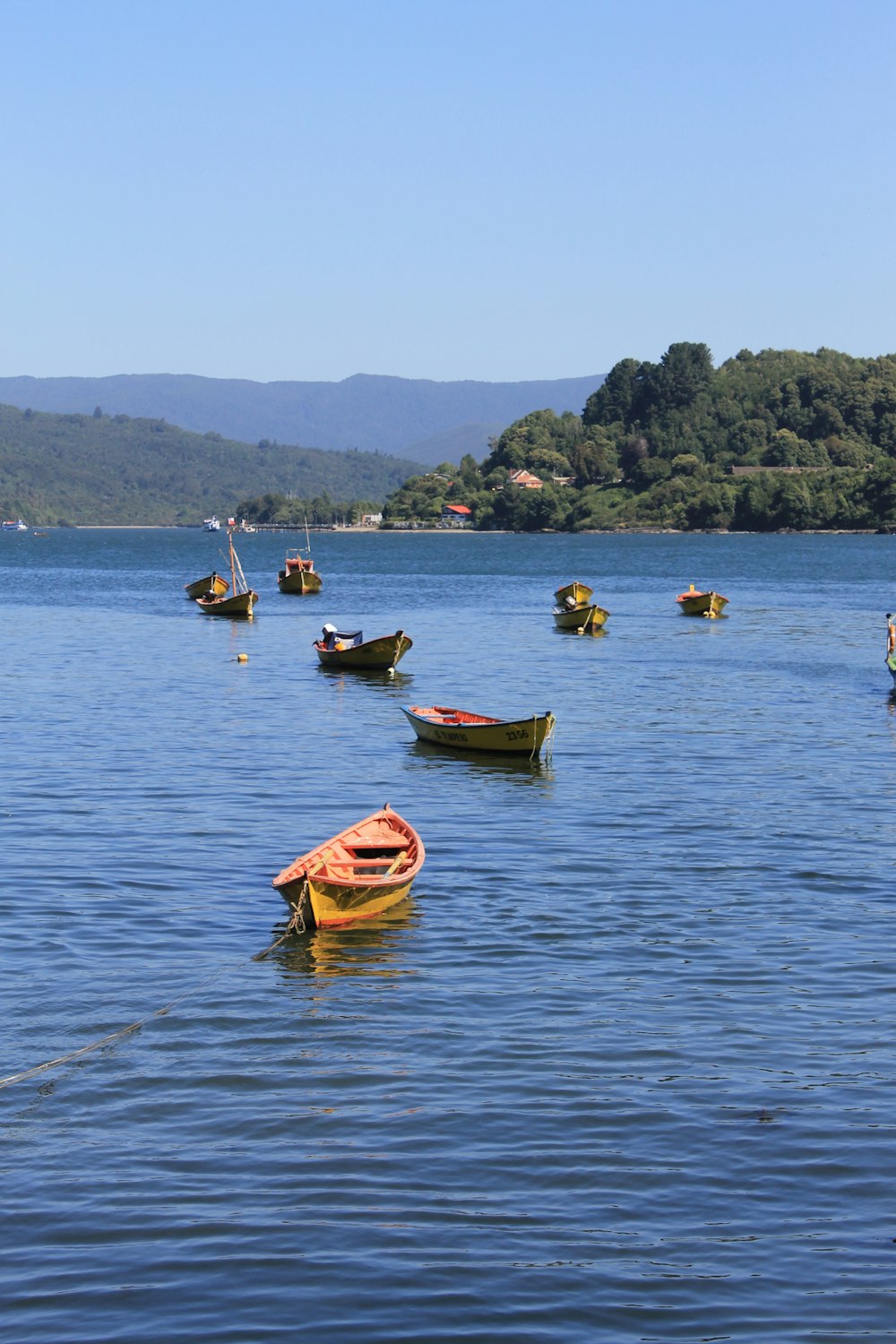 a group of boats floating on top of a lake