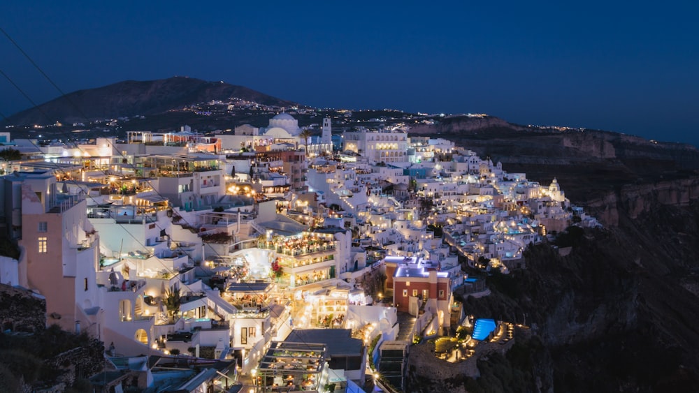 a night view of a town with a mountain in the background