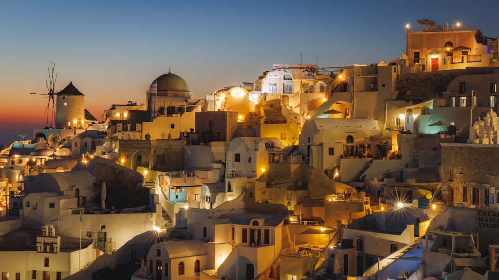 a view of a city at night with a windmill in the background