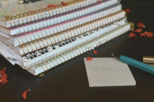 A stack of notebooks filled with handwritten poems and notes