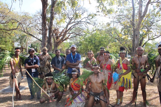 A community group gathered outdoors during a cultural event in a natural setting.