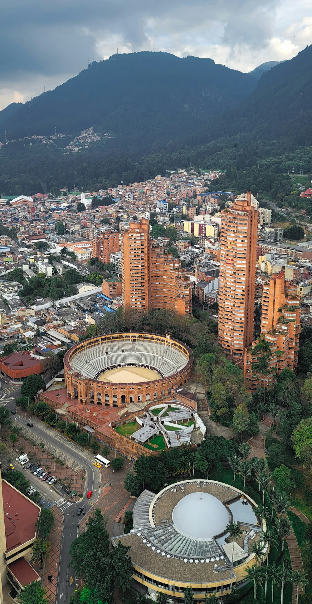 an aerial view of a city with mountains in the background