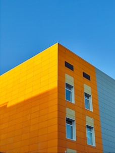 A modern house with a blue and orange facade.