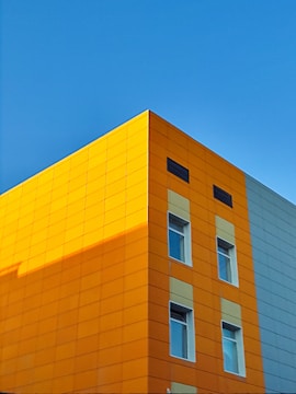 Bright and modern urban building facade with orange accents.