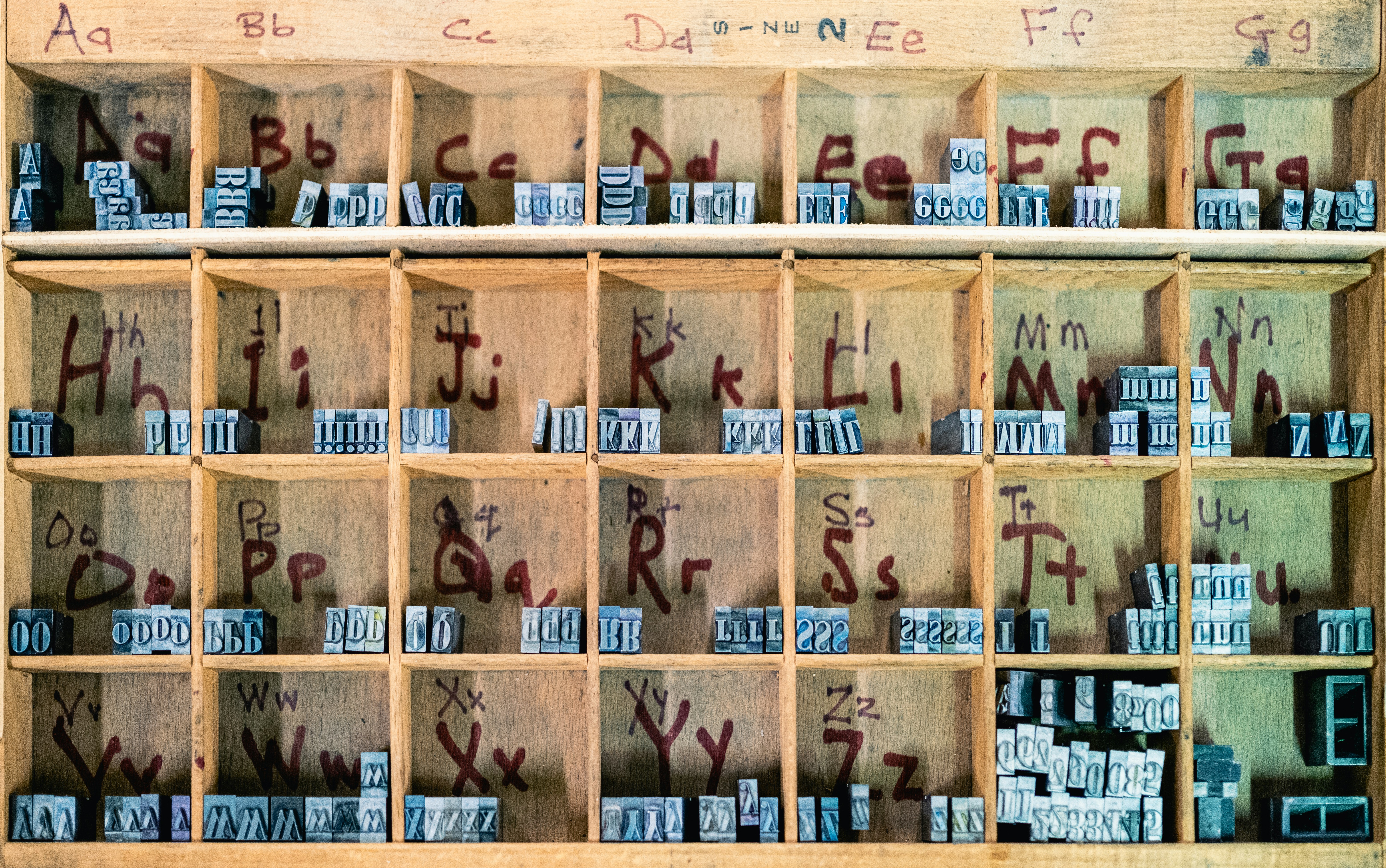 A wooden shelf filled with lots of letters and numbers photo Free