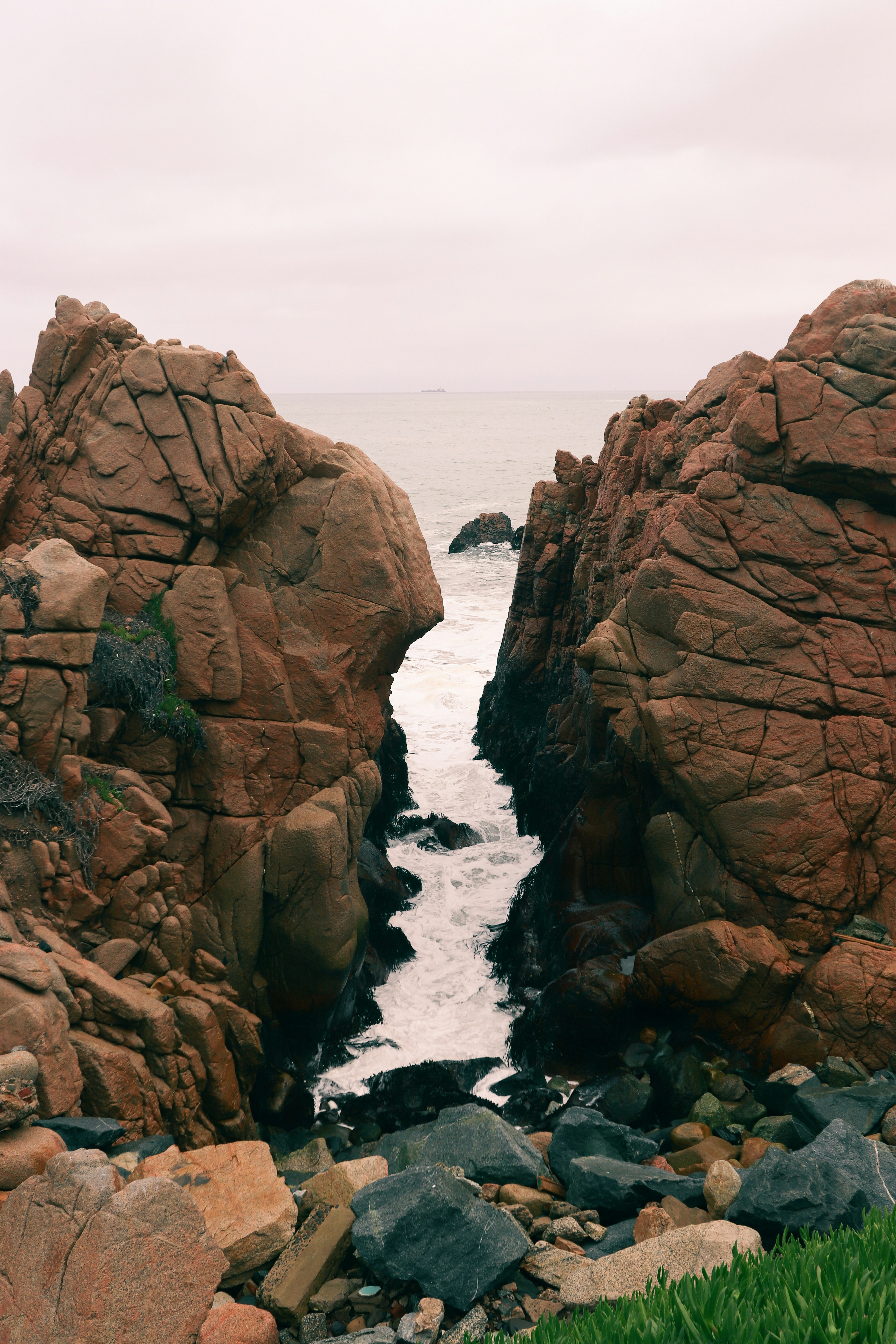 a couple of large rocks sitting on top of a beach