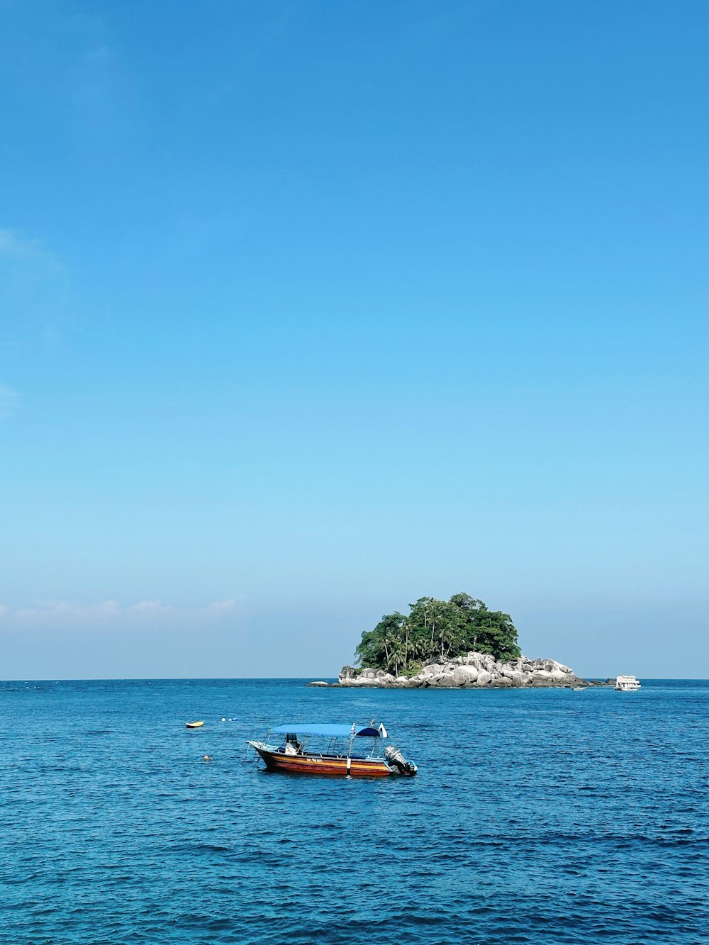 a small boat floating on top of a large body of water