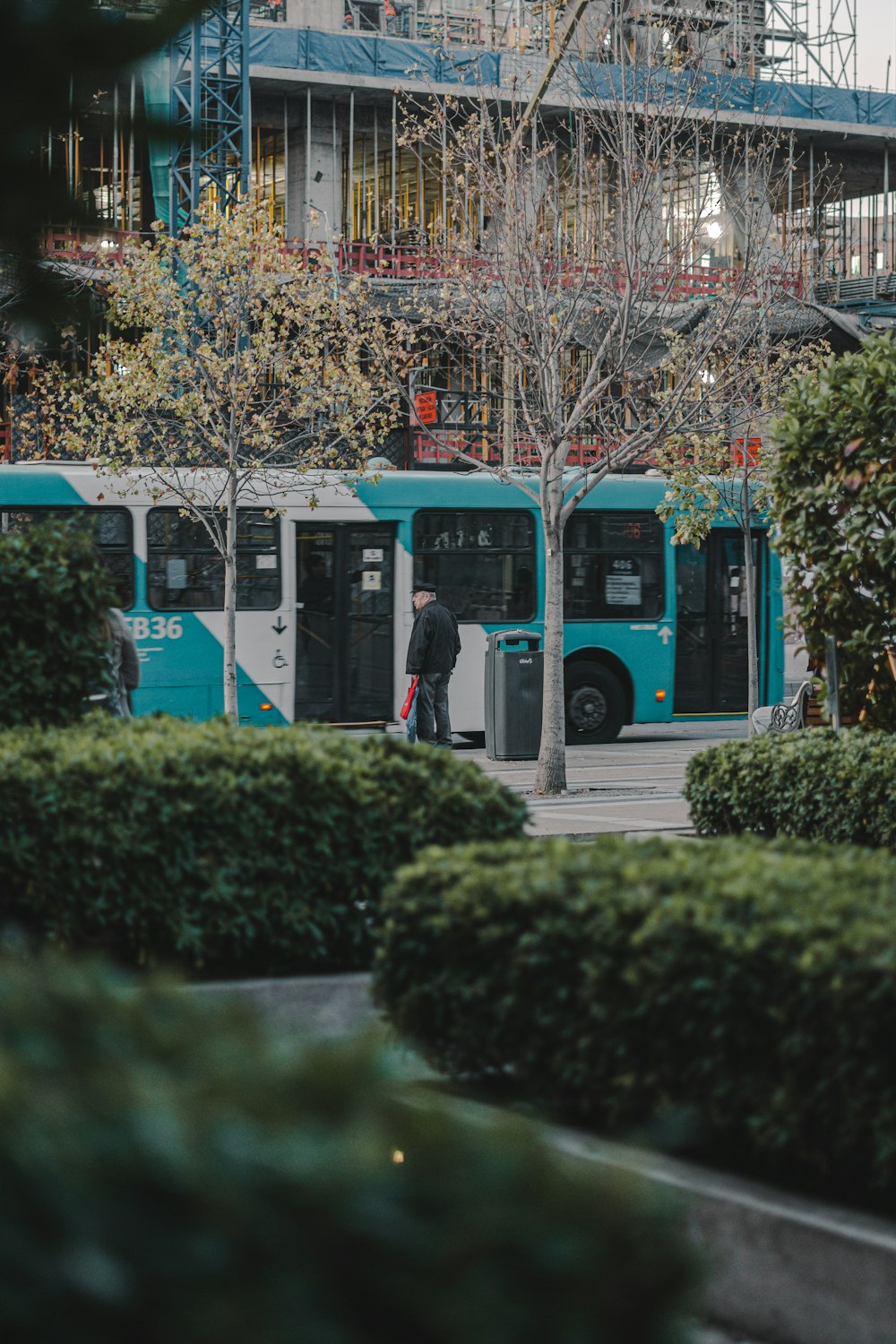 a blue and white bus parked in front of a building