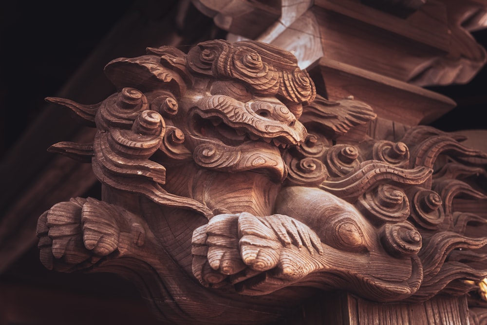 a wooden carving of a lion on a building