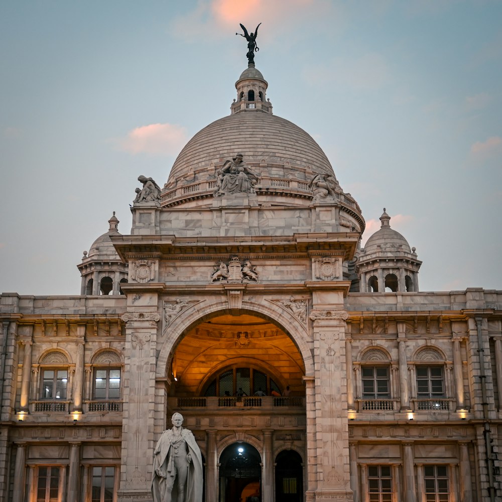 a large building with a statue in front of it