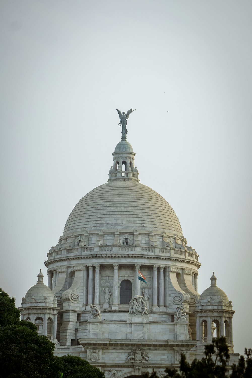 the dome of a building with a statue on top