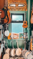 A cozy rehearsal space with various musical instruments displayed.