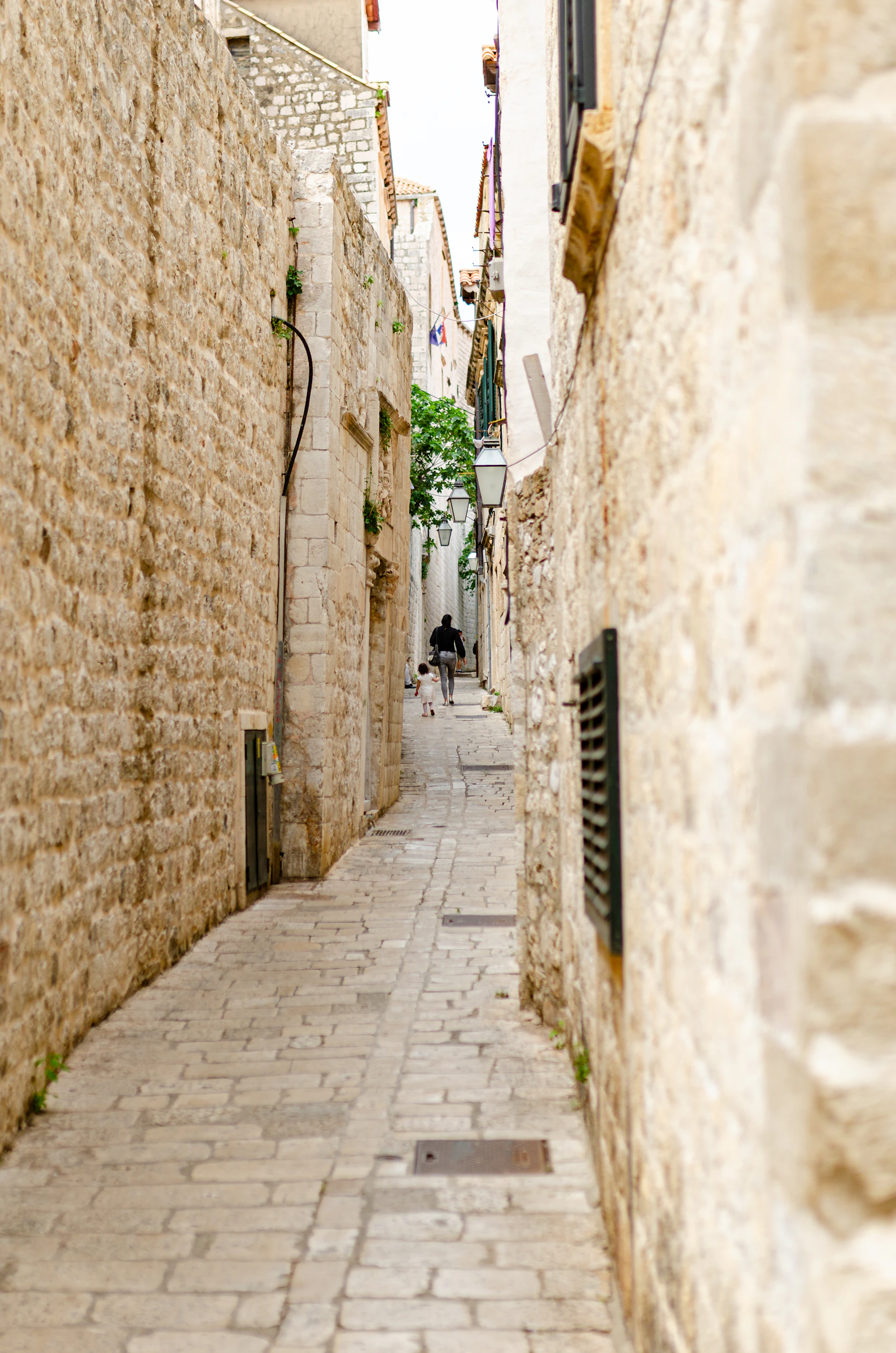 A narrow stone street with steps between old buildings in Dubrovnik