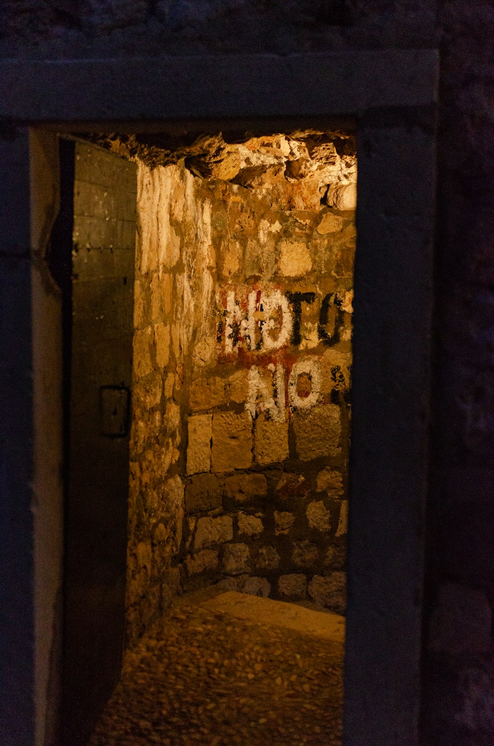 a dark tunnel with graffiti on the walls