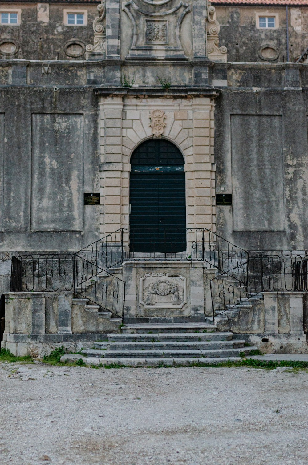 an old building with a clock on the front of it