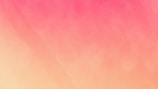 A gradient background blending from a soft yellow at the bottom to a vibrant pink at the top. The transition between colors is smooth and creates a warm, calming visual effect.
