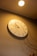 A stylish wall clock with a minimalist design hanging on a bright wall.