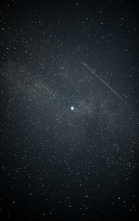 A vibrant mobile game scene featuring a celestial hero navigating a starry sky with biblical symbols glowing around