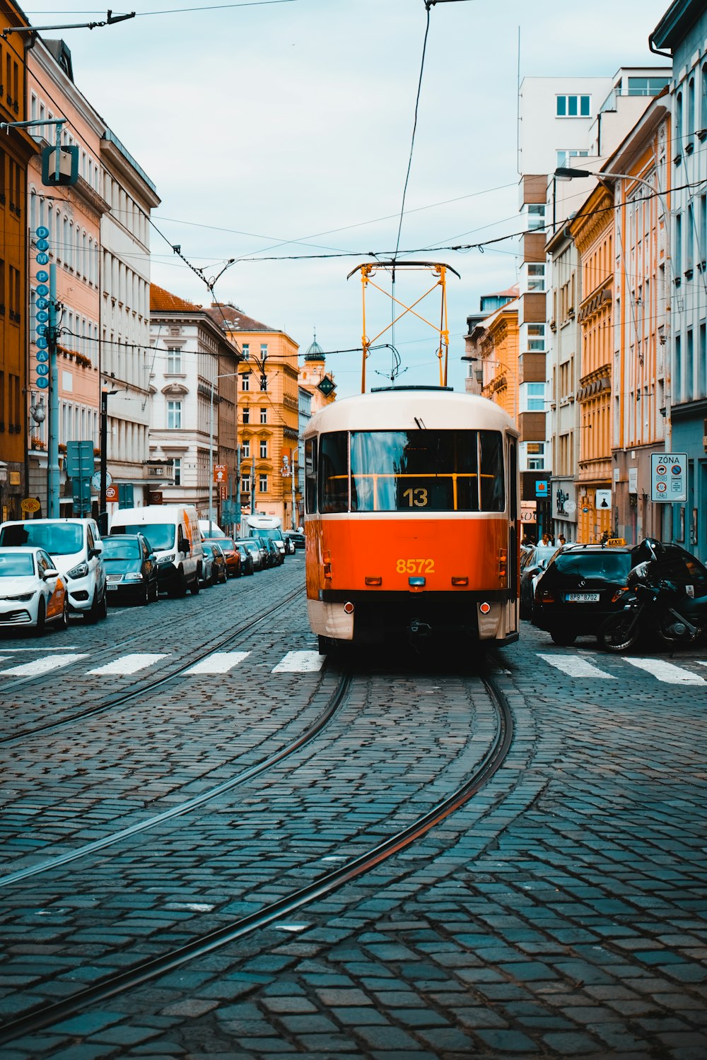 a trolley car is traveling down a cobblestone street