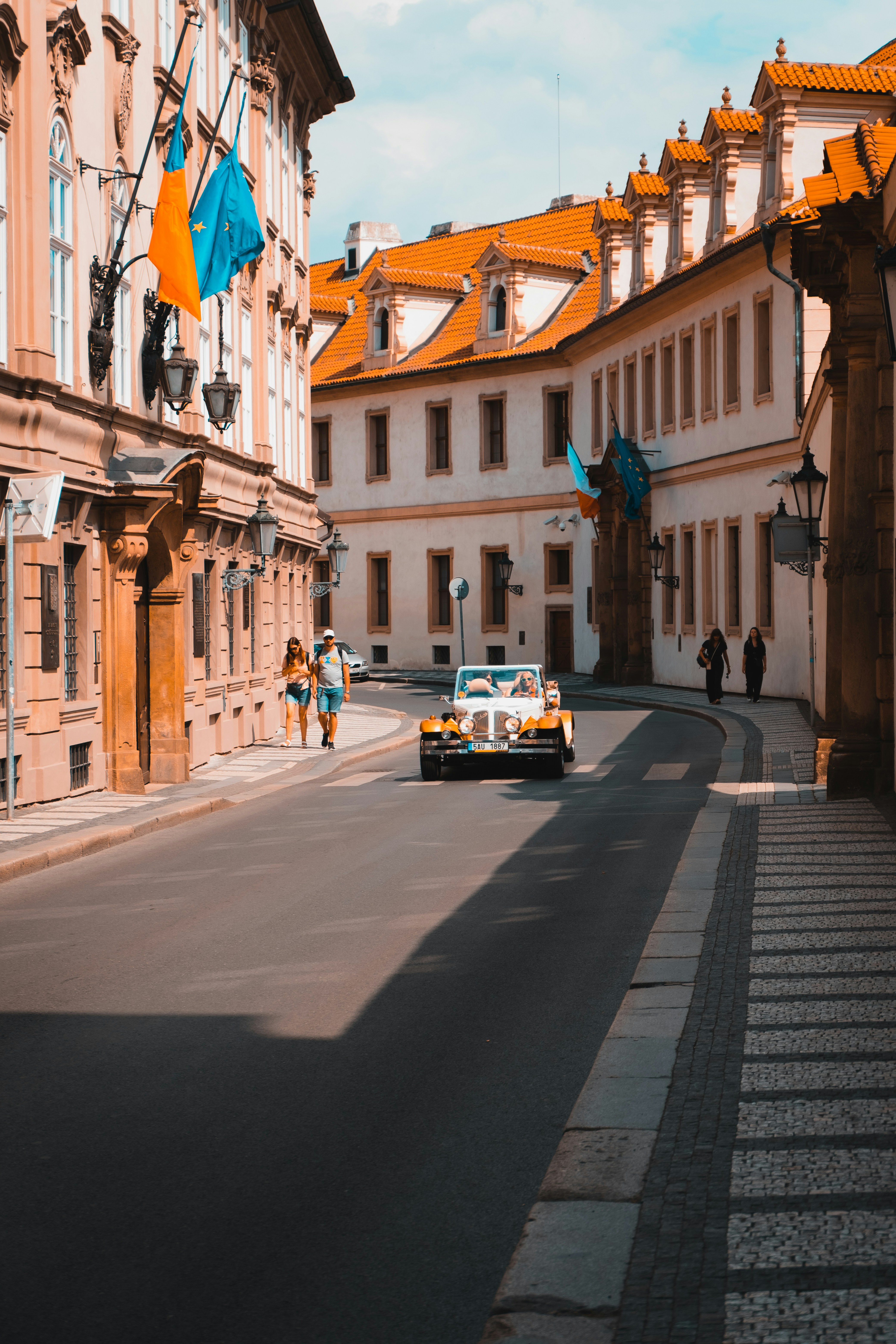 a car driving down a street next to tall buildings