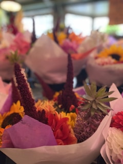 A colorful spring collection of floral tops in a bright studio.