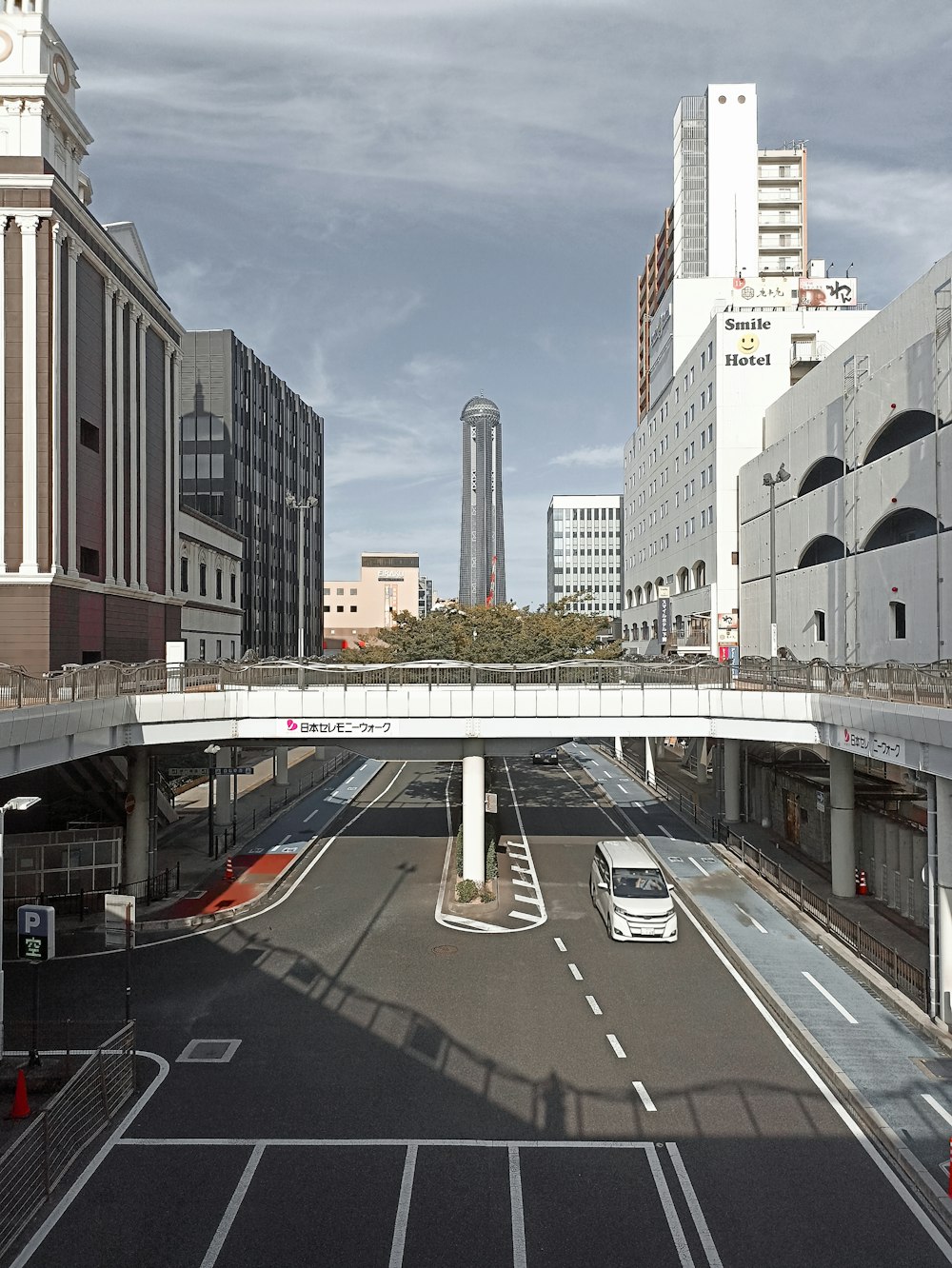 a city street with a bridge over it