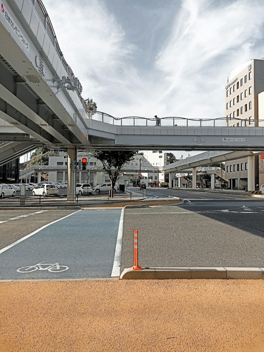 an empty parking lot with a bridge over it