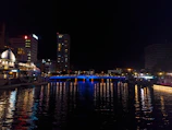 Night view of Aguascalientes city lights reflecting on a calm river.