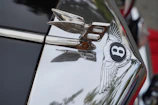 A polished chrome emblem reflecting a perfectly restored car interior, highlighting clarity and precision.
