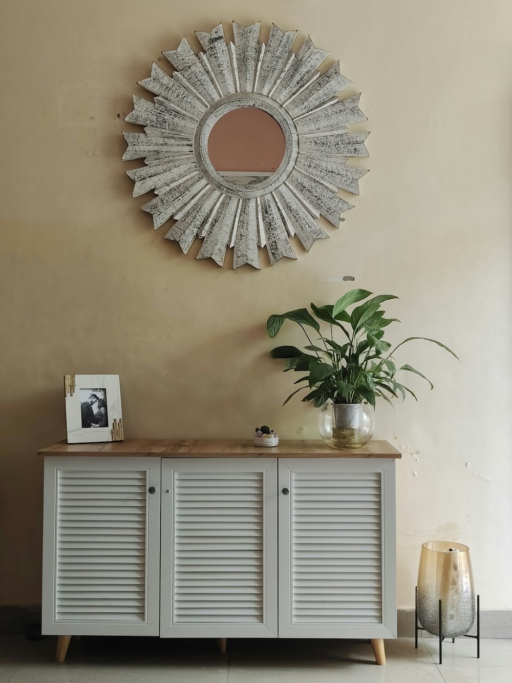 a white cabinet with a mirror above it