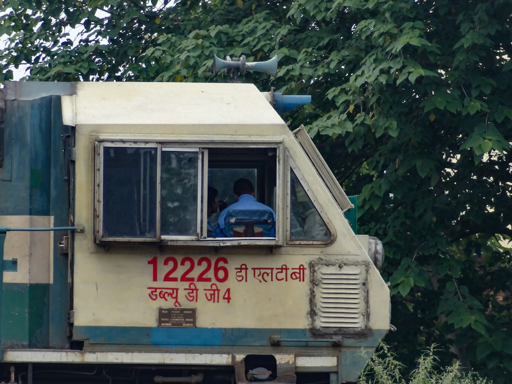 a man sitting in the window of a moving truck