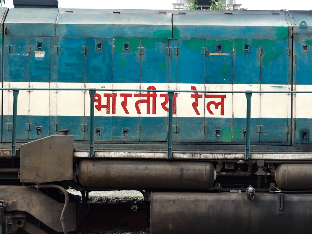 a blue and white train with red writing on the side