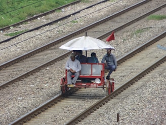 A group of friends laughing and pedaling together on a bright red Charlotte Pedal Co trolley through downtown Charlotte.
