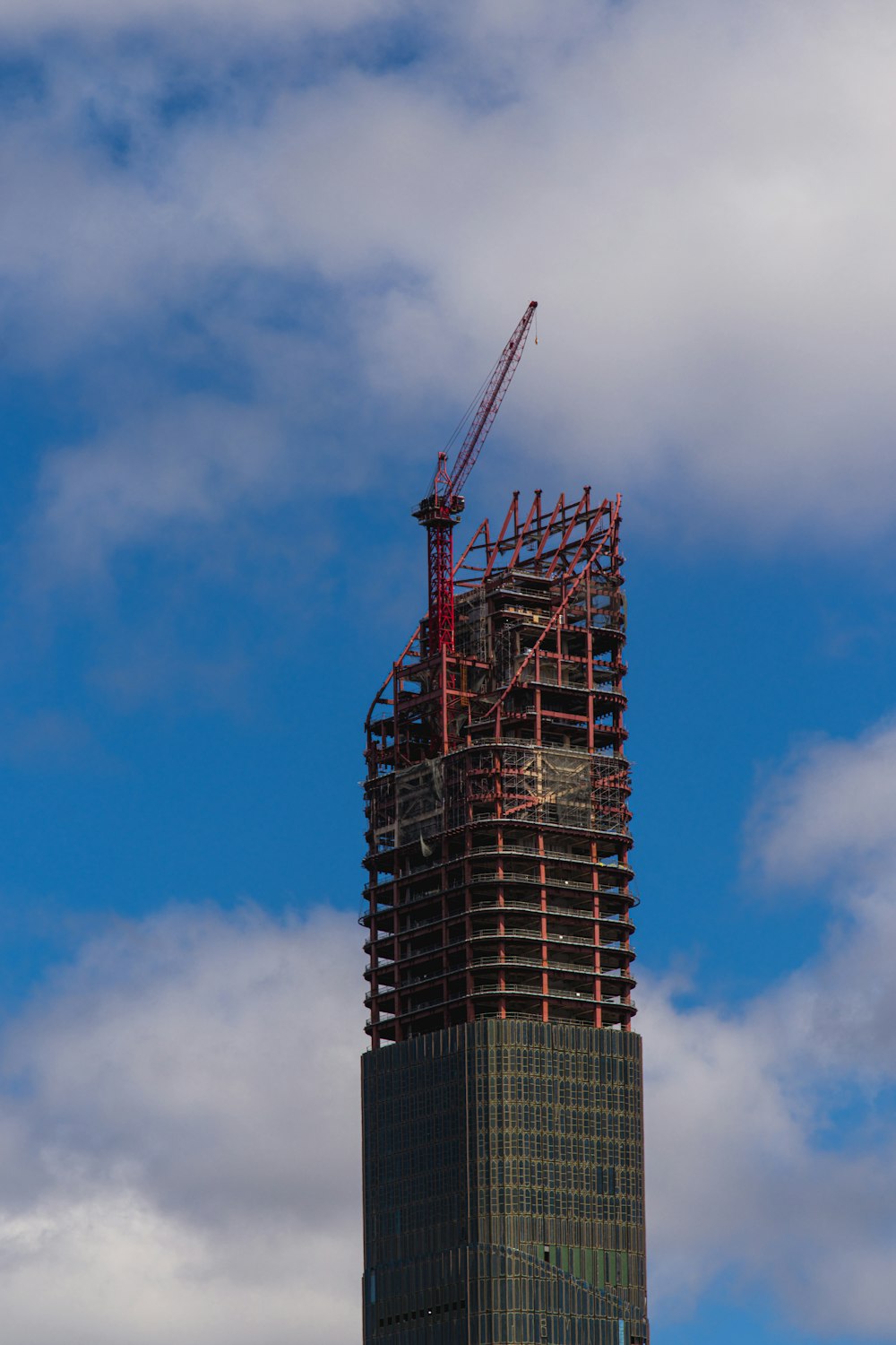 a tall building with a crane on top of it