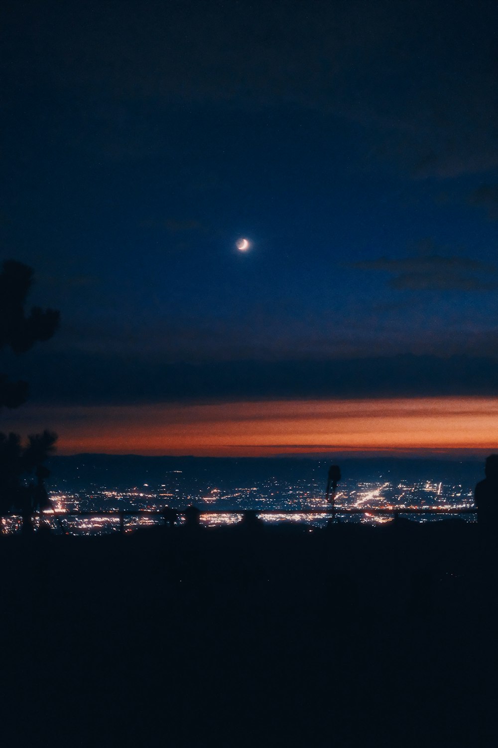 a view of a city at night from a hill