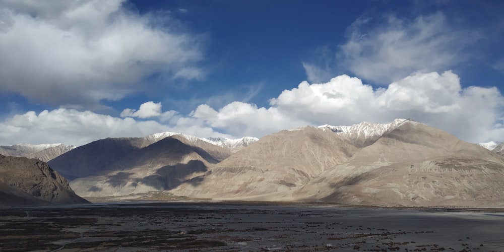 a mountain range with a body of water in the foreground