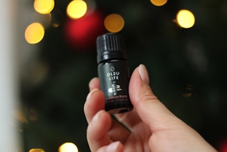 A small 5oz bottle of spiced vanilla krema with coconut accents, styled with festive gold ribbons.