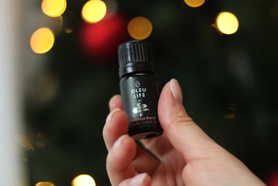 A small 5oz bottle of spiced vanilla krema with coconut accents, styled with festive gold ribbons.