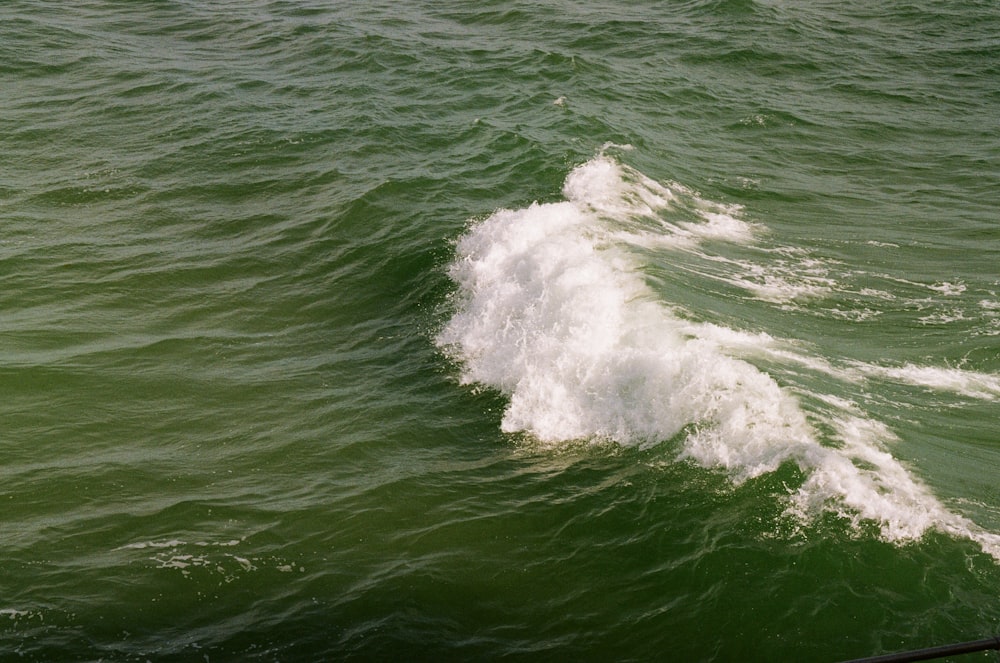 a person riding a surfboard on a wave in the ocean