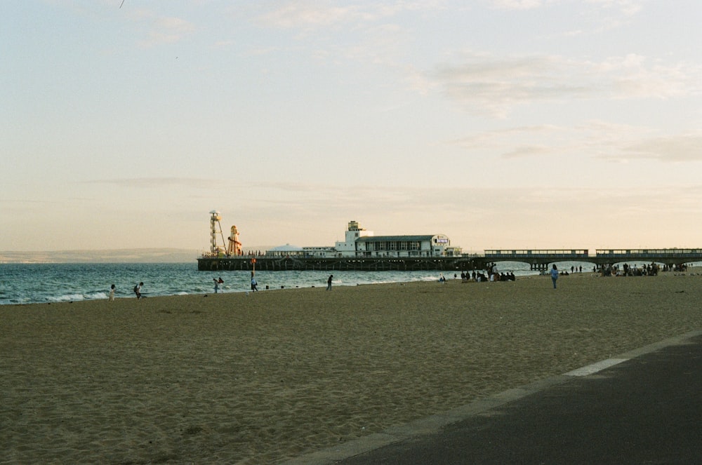 a group of people standing on top of a sandy beach