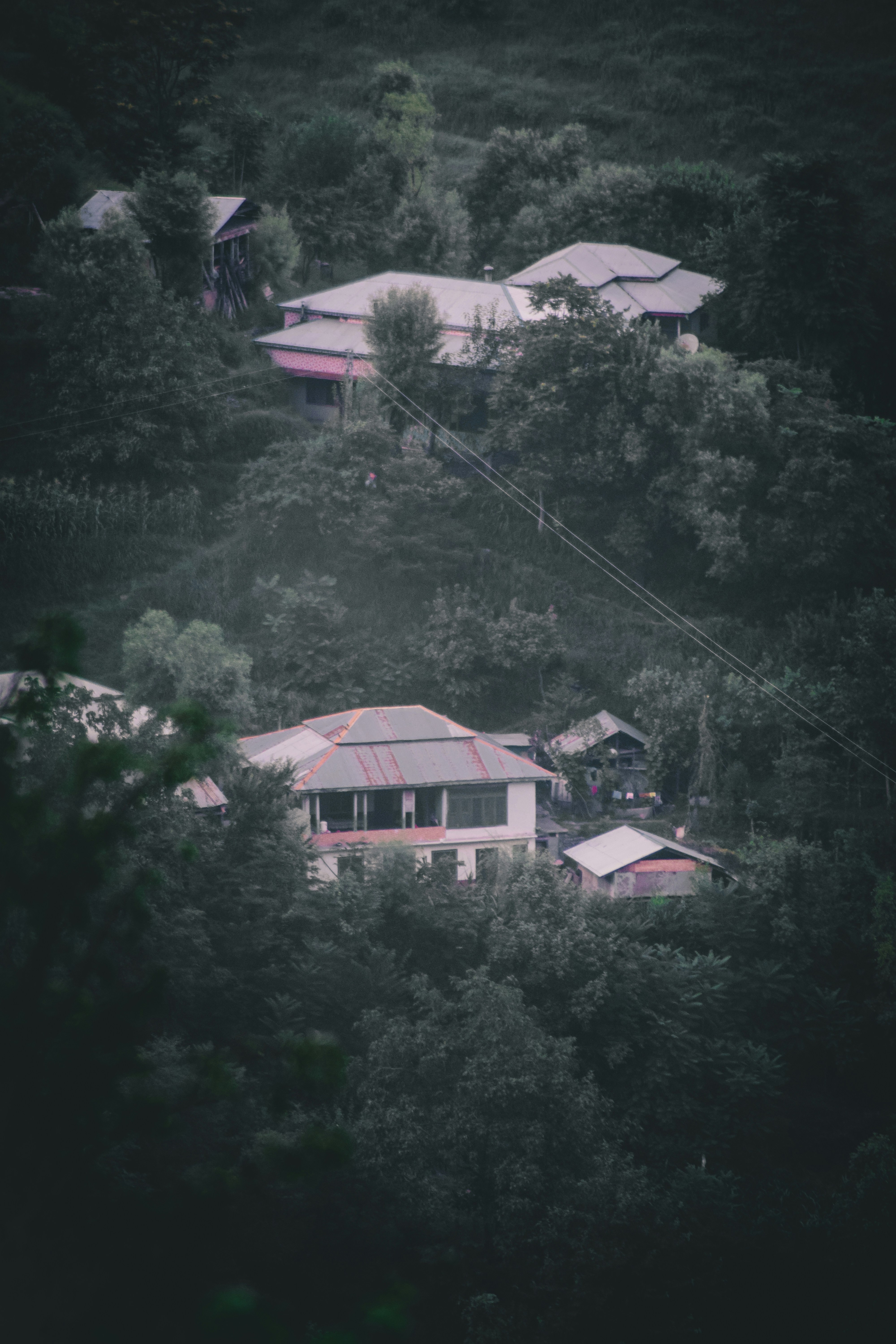 an aerial view of a house surrounded by trees