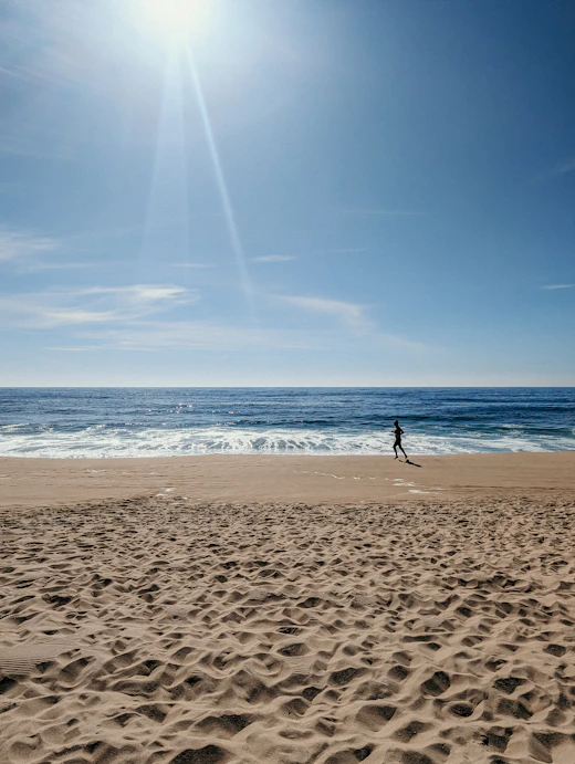 A lone figure on the beach watching the swell